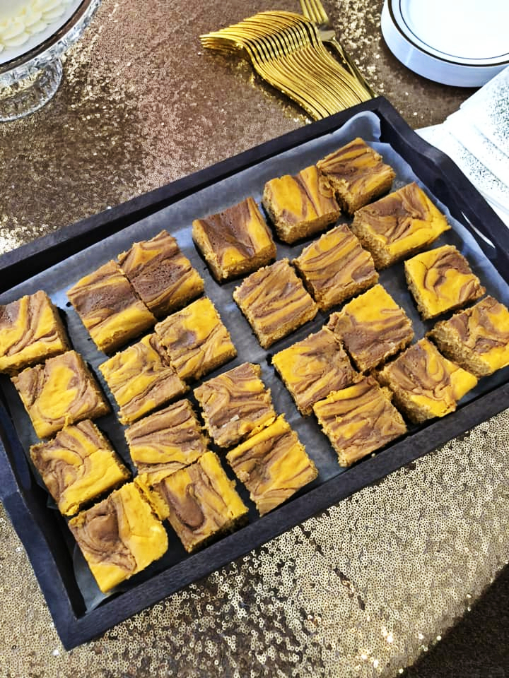 Double caramel pumpkin cheesecake bars on a tray