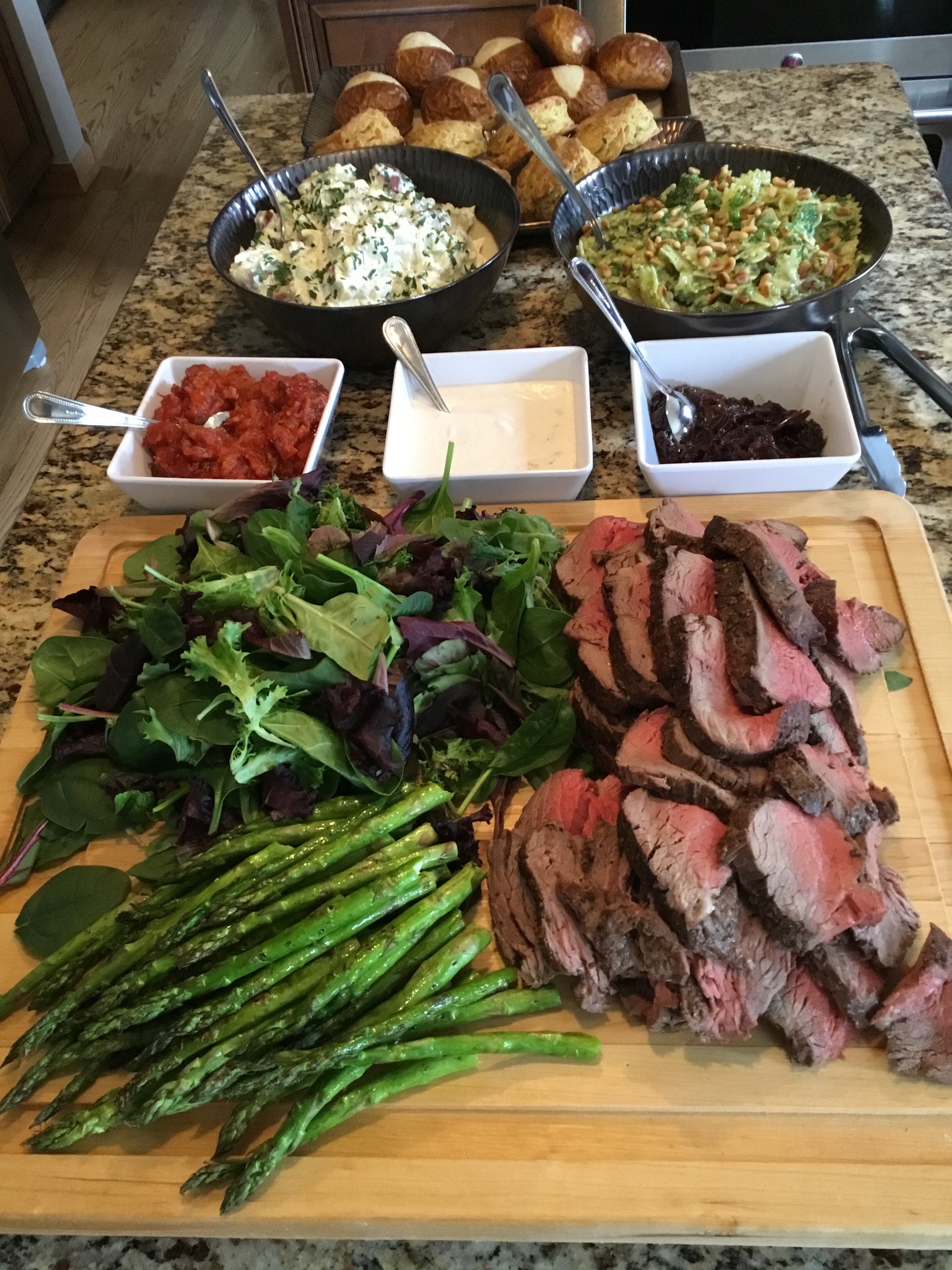 Roast beef tenderloin board with grilled asparagus, greens, tomato bacon jam, horseradish cream, and balsamic Bermuda onions